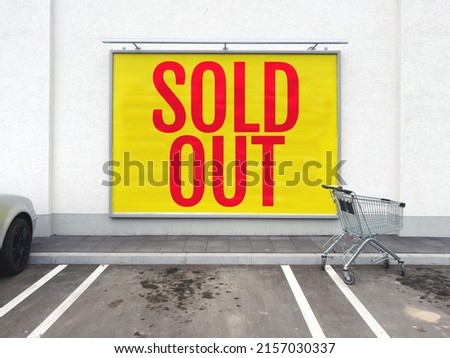 Sold out billboard poster at supermarket retail store wall, red letters on yellow background