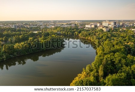 Bucharest from above, aerial view over Herastrau (King Michael I) Park, lake and the north part of the city with office building photographed during a summer sunset. Royalty-Free Stock Photo #2157037583