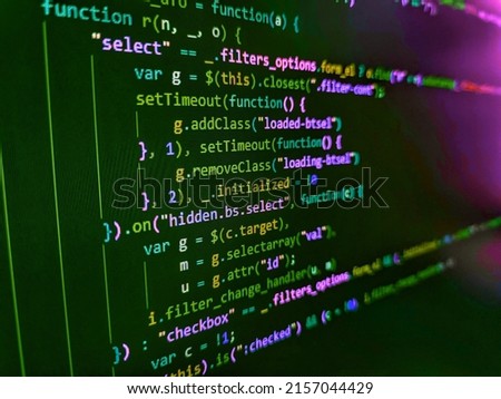 Minificated web development javascript code close up in sunset rays. Front-end applications in the color concept. Programming of Internet website. HTML code on lcd screen