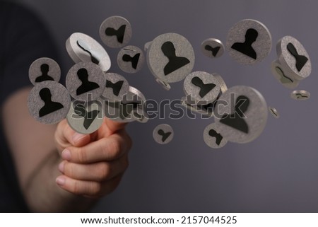An illustration of people icons near a hand