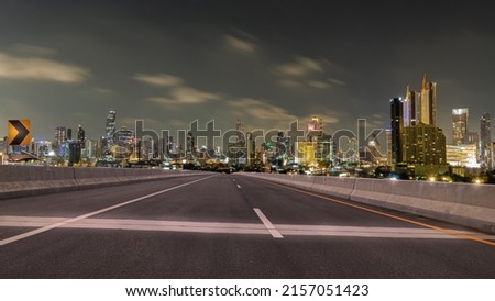 Empty asphalt road and Bangkok city at night skyline background Royalty-Free Stock Photo #2157051423