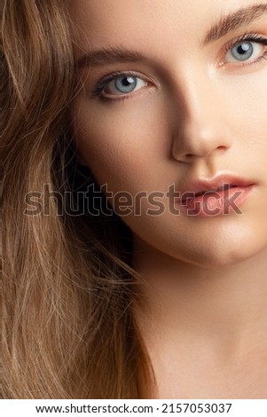 Closeup of beauty woman with clean shiny skin and natural cosmetics. Beautiful extrem eyelash and plump lips of a well-groomed girl demonstrate spa procedures, injections in a beauty parlor