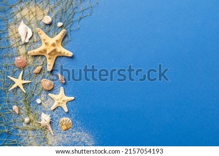 Summer time concept Flat lay composition with beautiful starfish and sea shells on colored table, top view with copy space for text.