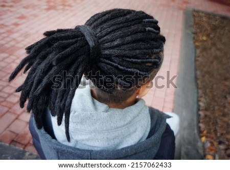 men's dreadlocks hairstyle gathered in a ponytail, back view Royalty-Free Stock Photo #2157062433