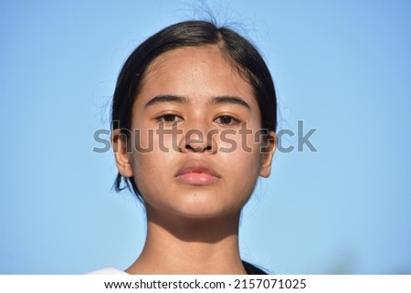 A Serious Asian Female Teenager Isolated Royalty-Free Stock Photo #2157071025