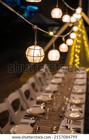 a Capiz shell ball lantern that sets the mood of a private dining dinner at the beach