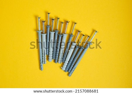 dowels for construction on a yellow background close-up