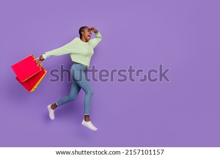 Full size profile side picture of overjoyed young lady see huge discount run to buy new dress isolated on purple color backgroimd