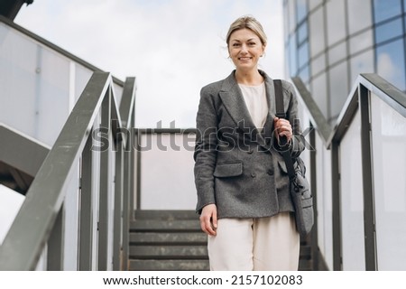 Portrait of a mature business woman on a modern office and urban background