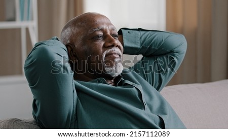 Calm serene elderly adult African American man relaxing with eyes closed take break relax at home office, old grandpa enjoying rest feel peace Dominican senior businessman napping on comfortable couch Royalty-Free Stock Photo #2157112089