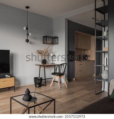 Stylish, open plan studio apartment with home office area in living room and modern, small kitchen Royalty-Free Stock Photo #2157112973