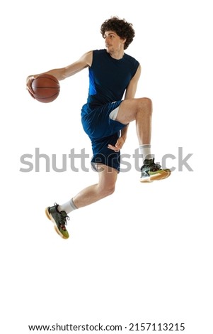 Competitive. Young muscular basketball player in action, motion isolated on white background. Concept of sport, movement, energy and dynamic, healthy lifestyle. Copy space for ad Royalty-Free Stock Photo #2157113215