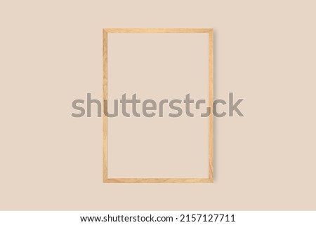 A wooden triangle blank picture frame on a bright wall background