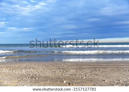 Beach shore. Waves at sea. Waves at sea during storm and wind. Wave from the sea goes on land to the beach. Splashing Waves in ocean, background, texture. Wave at Rising Storm. Sea wave in ocean.