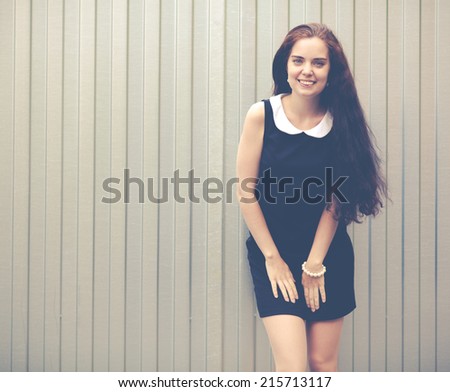 Young pretty crazy funny girl have fun and goes wild alone on the street on white background urban style