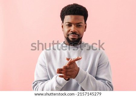 Black mid man with beard smiling and rubbing his hands isolated over pink background Royalty-Free Stock Photo #2157145279
