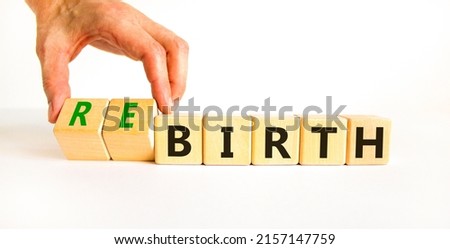 Birth or rebirth symbol. Businessman turns wooden cubes and changes the word birth to rebirth. Beautiful white table white background, copy space. Business, birth or rebirth concept. Royalty-Free Stock Photo #2157147759