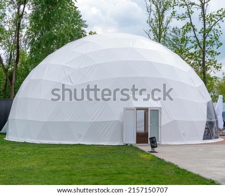 White mobile dome design. Outside spherical glamping dome. Hemispherical structure lattice shell geodesic polyhedron. Camping house hotel party tent. Folk accommodation park outdoor leisure recreation Royalty-Free Stock Photo #2157150707