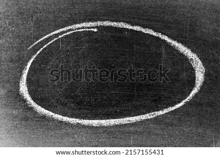 White chalk hand drawing as circle or round shape on blackboard or chalkboard background with copy space Royalty-Free Stock Photo #2157155431