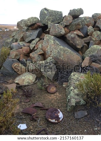Rusty metal artefacts lying near an Anglo Boer War archaeological site - South Africa. Royalty-Free Stock Photo #2157160137