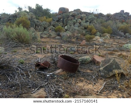 Rusty metal artefacts lying near an Anglo Boer War archaeological site - South Africa. Royalty-Free Stock Photo #2157160141