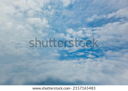 Summer cloudy blue sky background. Panoramic view with beautiful clouds. Horizontal cloudscape. High-resolution photography. Design element. Abstract nature background. Copy space.