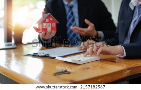 Real estate agent talked about the terms of the home purchase agreement and asked the customer to sign the documents to make the contract legally, Home sales and home insurance concept