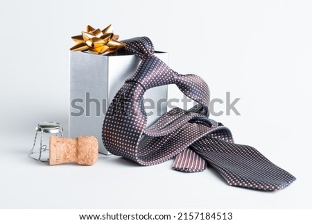 The representation of Father's Day with still life - tie, gift box and a champagne lid Royalty-Free Stock Photo #2157184513