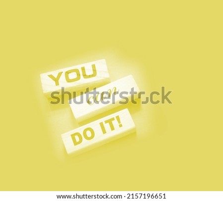 YOU CAN DO IT word on wooden blocks on gray background. Motivation affirmation encouraging words for personal achievements concept.