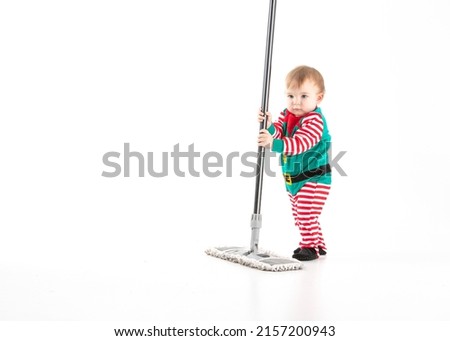 Stock studio photo with white background of a baby disguised as a elf with a mop