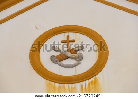 Christian symbol crossed arms and a cross on the facade of the Catholic church of St. Francis in the center of Florianopolis Brazil