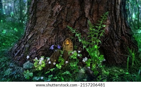 tree with Little fairy wooden door in forest, natural background. Fairy tale tree house in woodland, pixie or elf home. beautiful mystery magic atmosphere. template for design