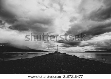 A grayscale shot of cloudscape above the lake  Royalty-Free Stock Photo #2157218477