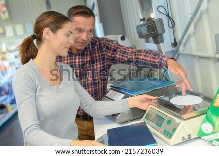 Man and woman calibrating scales