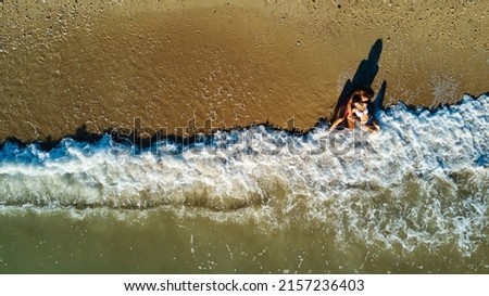 Aerial top down view of romantic couple portrait at the beach.