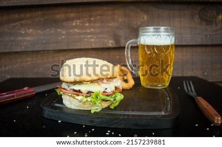 a closeup of a big juicy hamburger on a wooden board