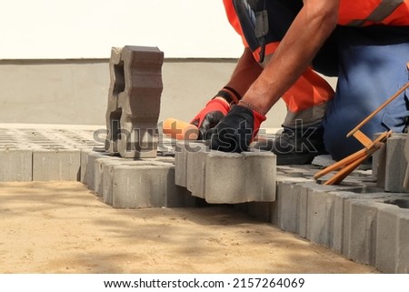 Pavement. Laying paving stones. Cube, openwork plate Royalty-Free Stock Photo #2157264069
