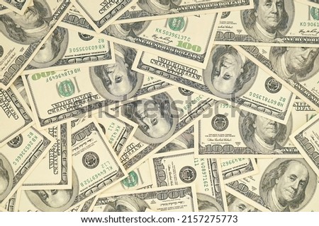 A pile of one hundred US banknotes with president portraits. Cash of hundred dollar bills, dollar background full frame image with high resolution