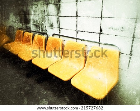 Old picture style Plastic yellow grunge chair with brick block background 