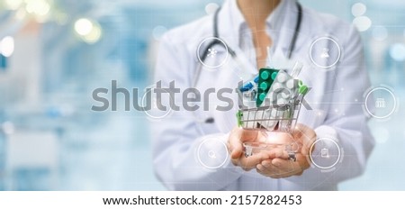 The concept of providing pharmacy services. Pharmacist shows a basket of medicines on a blurred background. Royalty-Free Stock Photo #2157282453