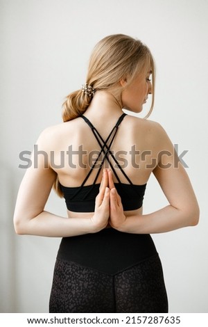 Sports girl clasps her hands behind her back Royalty-Free Stock Photo #2157287635