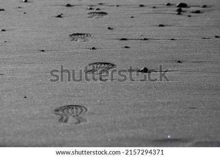Imprint of the shoe on mud with copy space, Footprint in the dirt, Foot step on sand, background texture. Top view.