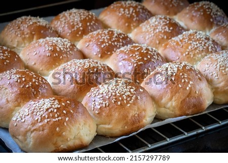 Round white flour buns with sesame seeds