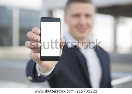 Businessman holding smartphone in hand Royalty-Free Stock Photo #215731222