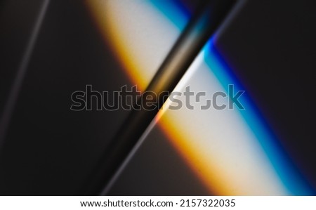 Beam of sunlight with spectrum colors goes over white wall, refraction effect. Abstract photo