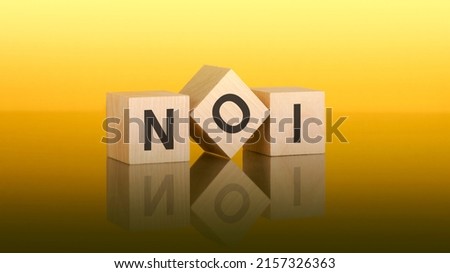 wooden blocks with text NOI on yellow baclground. question and answer concept