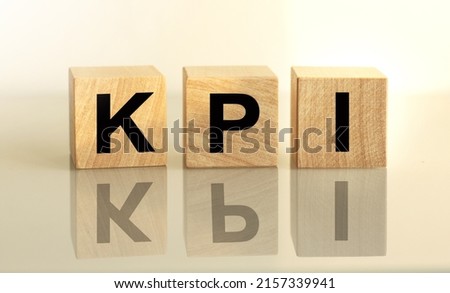 The inscription KPI on wooden cubes isolated on a light background, the concept of business and finance.
