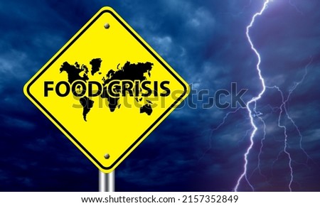 Problem hunger. Food crisis logo in front of world map. Yellow road sign on background thunderstorms. Concept solving problem of hunger at international level. Food crisis on different continents Royalty-Free Stock Photo #2157352849
