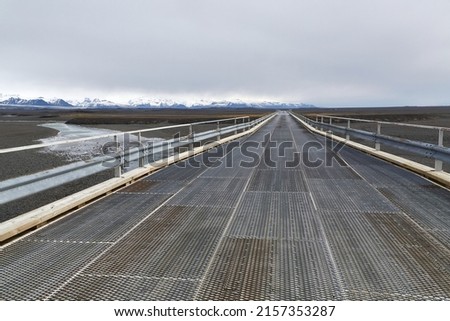 Single-lane bridge in Iceland along the Ring Road with wider spots where cars can pass each other Royalty-Free Stock Photo #2157353287
