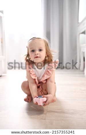 little cute girl sitting with toy camera